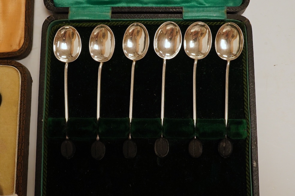 Two cased sets of six silver bean end coffee spoons, a Victorian silver bun salt, three assorted silver napkin rings, a small silver five bar toast rack and a sterling pen. Condition - poor to fair